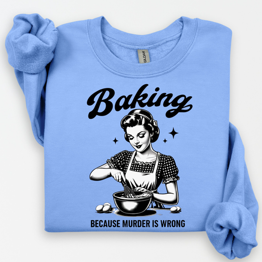 Light blue sweatshirt with a graphic of a woman baking and text 'Baking because murder is wrong' on a white background.