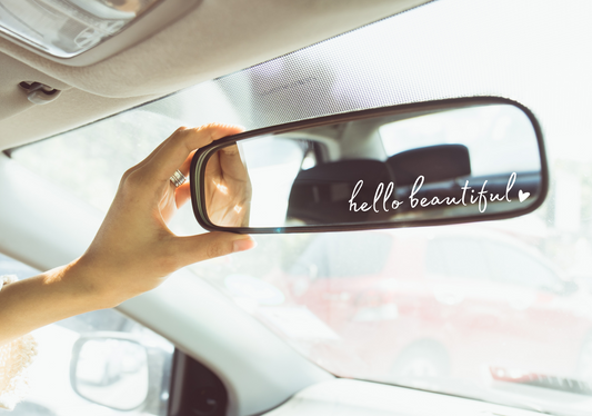 image of a rear view mirror with the decal that says hello beautiful