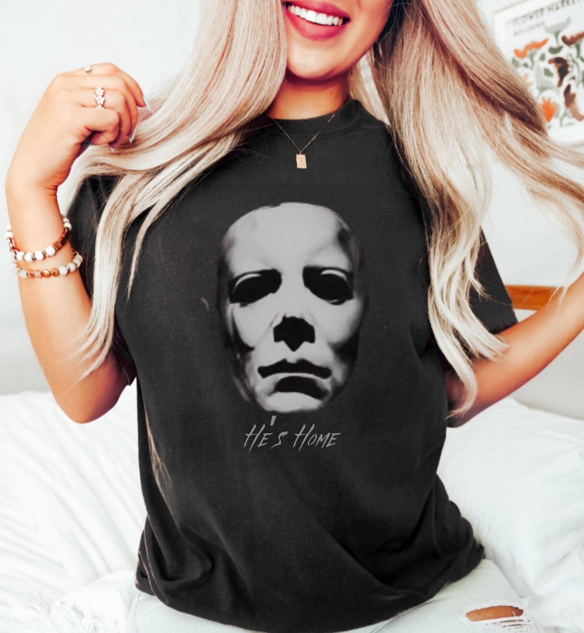 Person wearing a black t-shirt with a graphic design and text.
