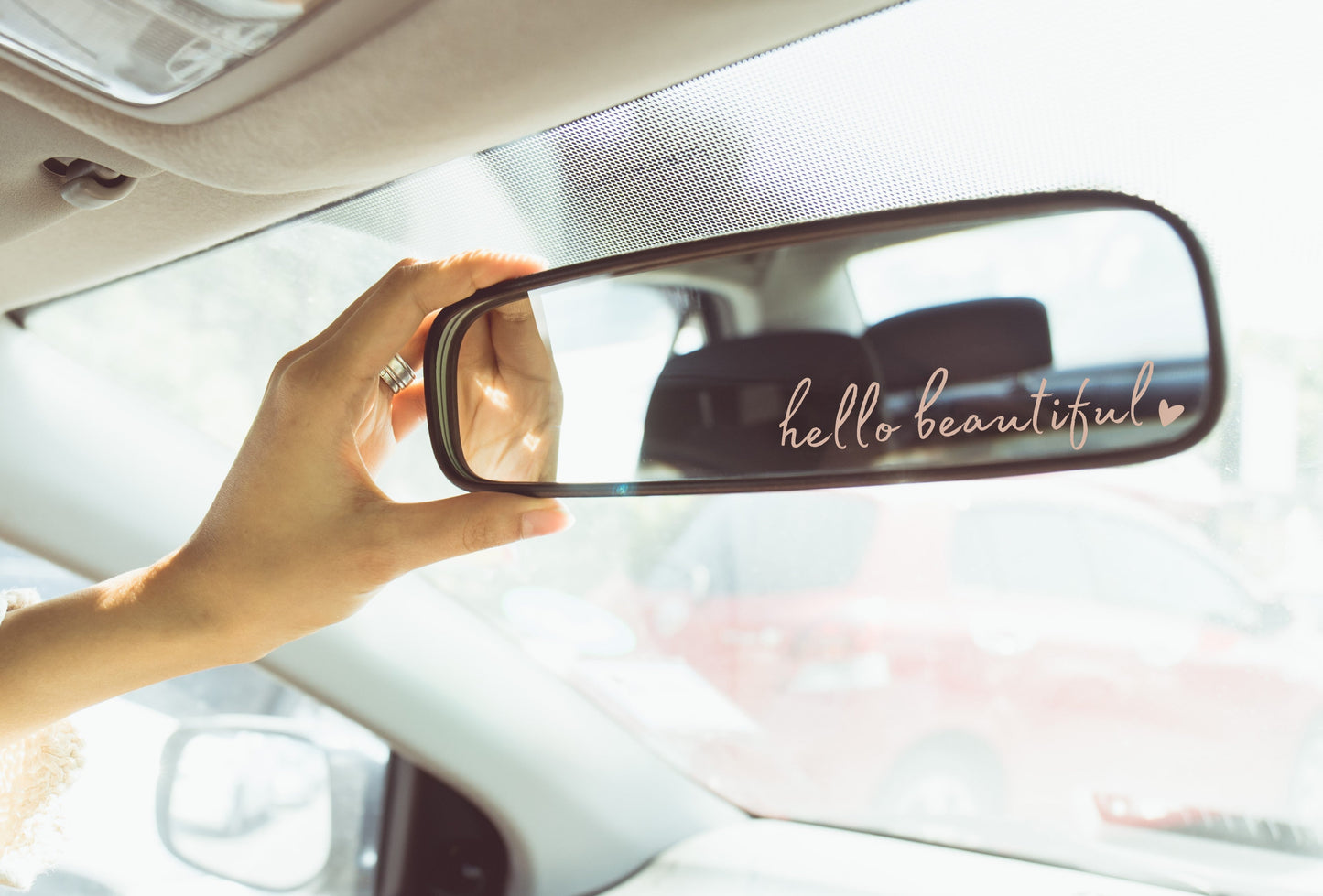 Image of a rear view mirror decal that says Hello Beautiful. 