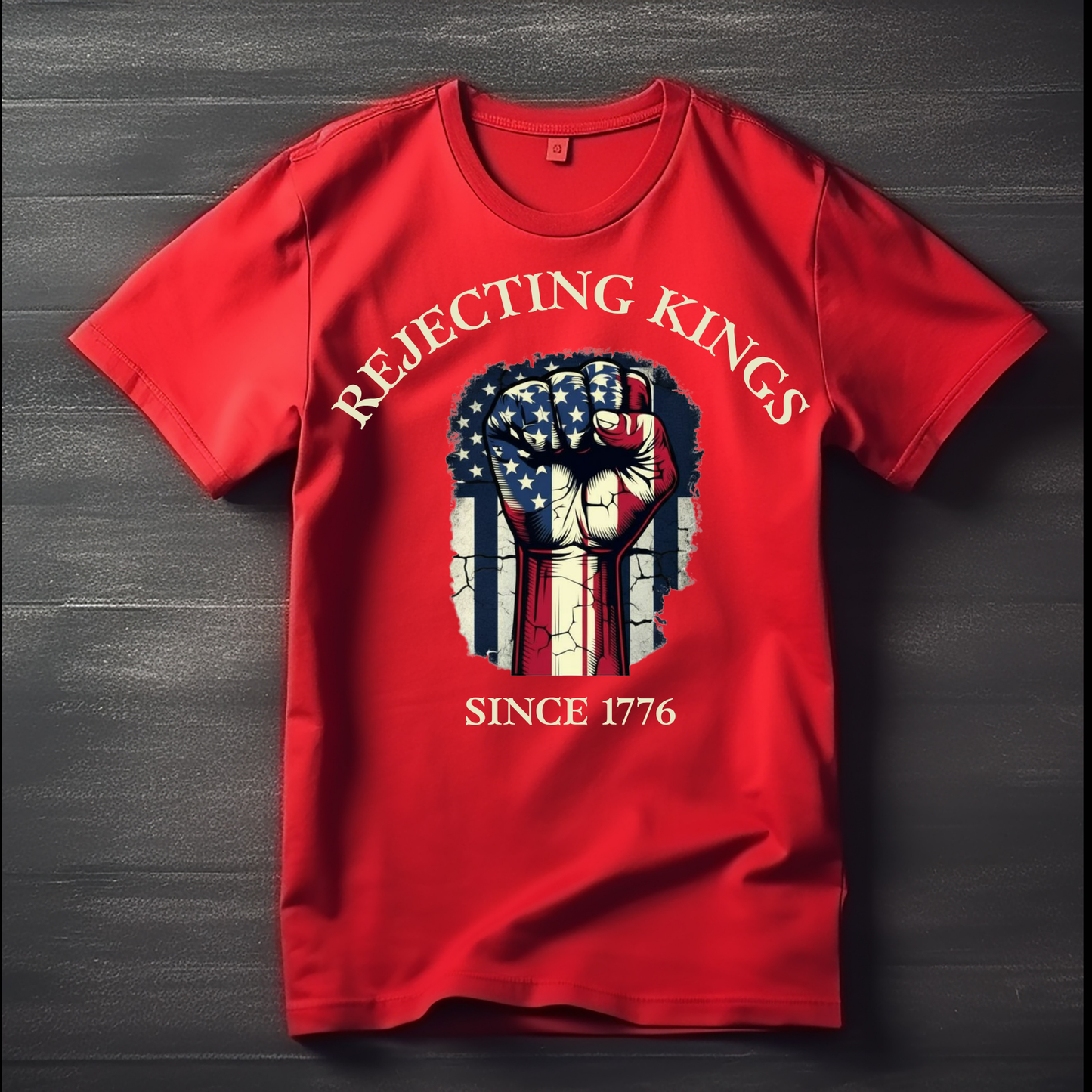 Red t-shirt with graphic design and text on a dark wooden surface