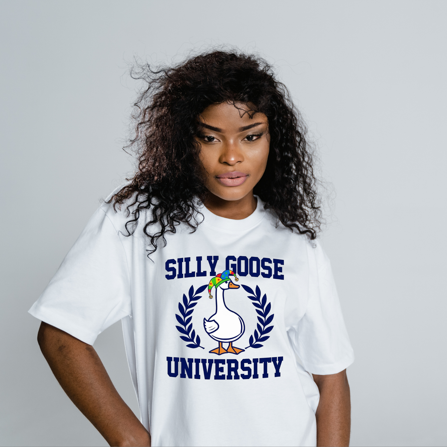 Person wearing a white t-shirt with 'Silly Goose University' design on a gray background