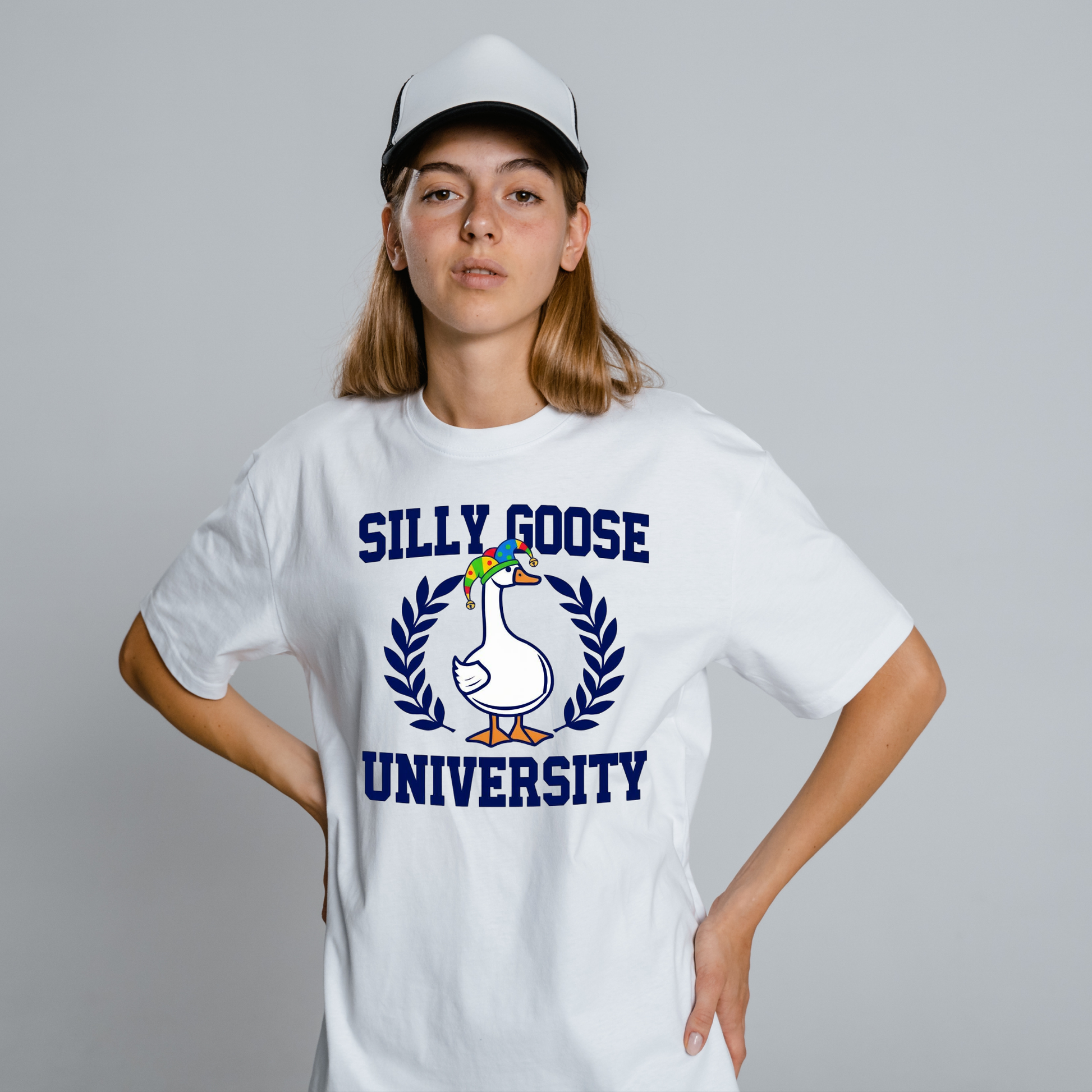 Person wearing a white t-shirt with 'Silly Goose University' design on a gray background