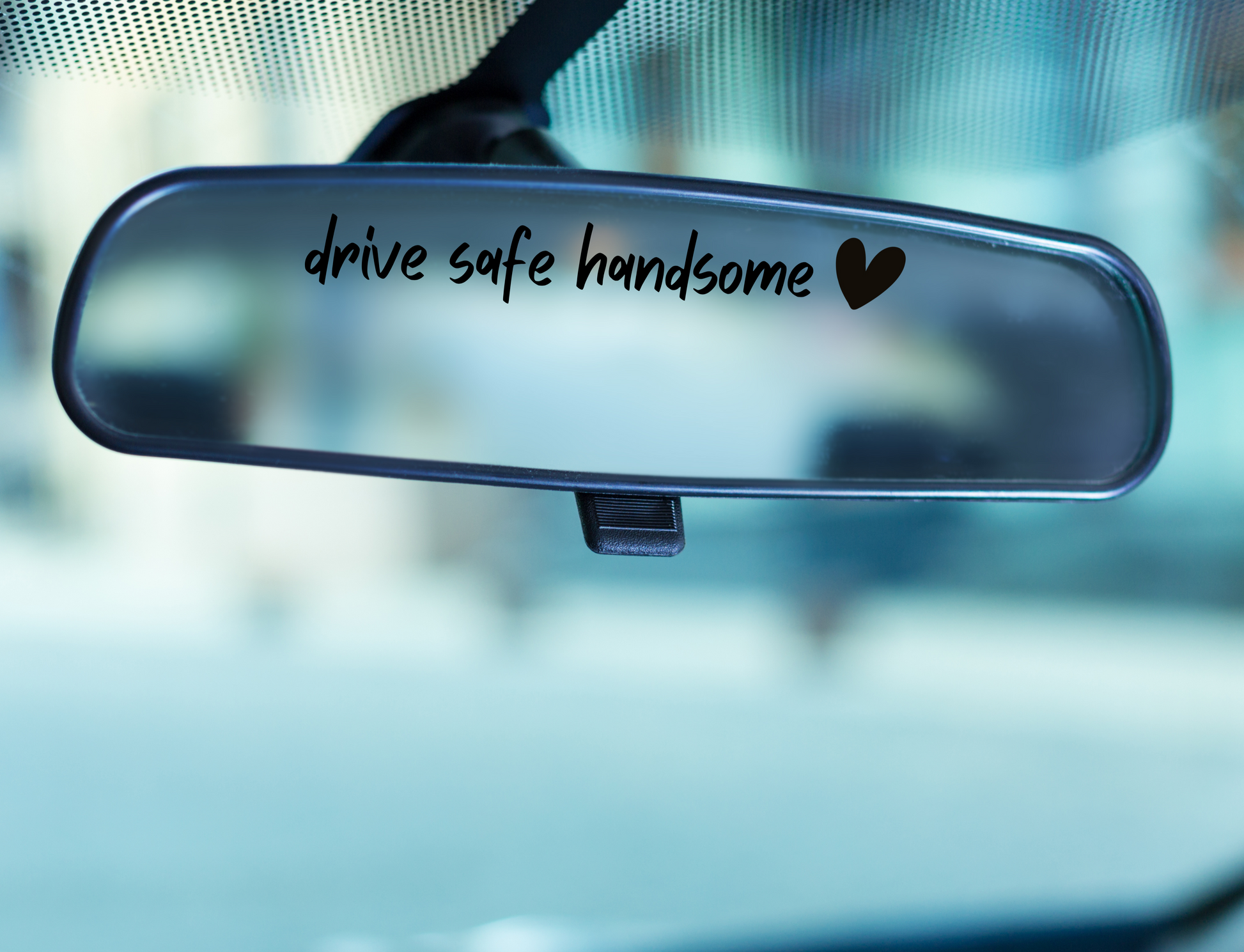 Drive safe handsome with a heart written in black handwriting on a rear view mirror 
