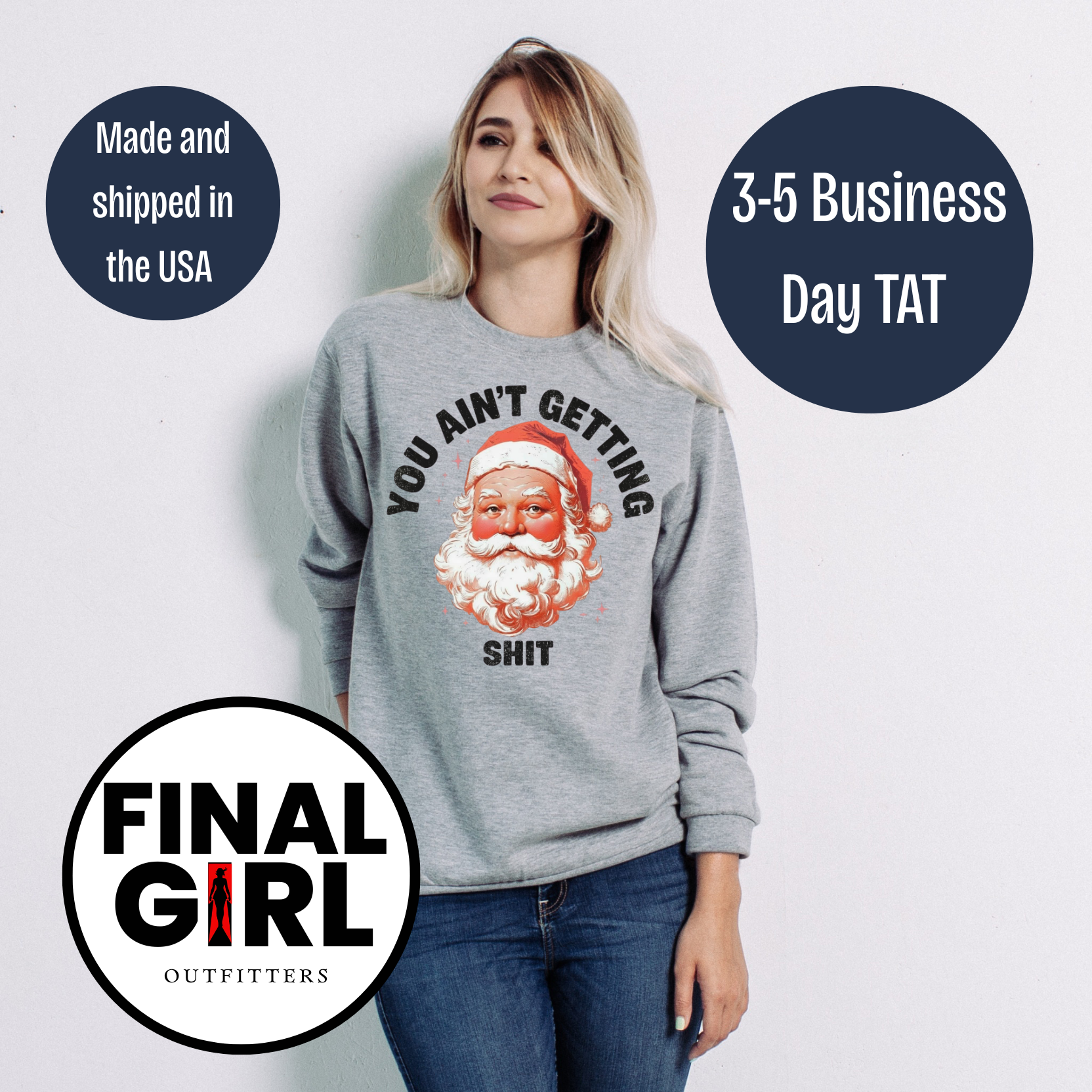 Person wearing a gray sweatshirt with a graphic design and text, standing against a white background.